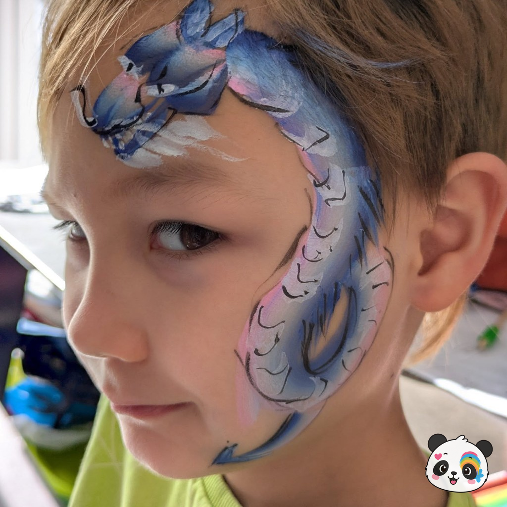 Blue and purple dragon face paint curling across a child's face